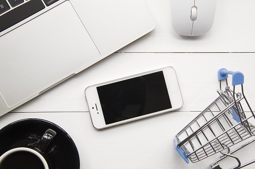 smartphone near laptop shopping trolley Copy